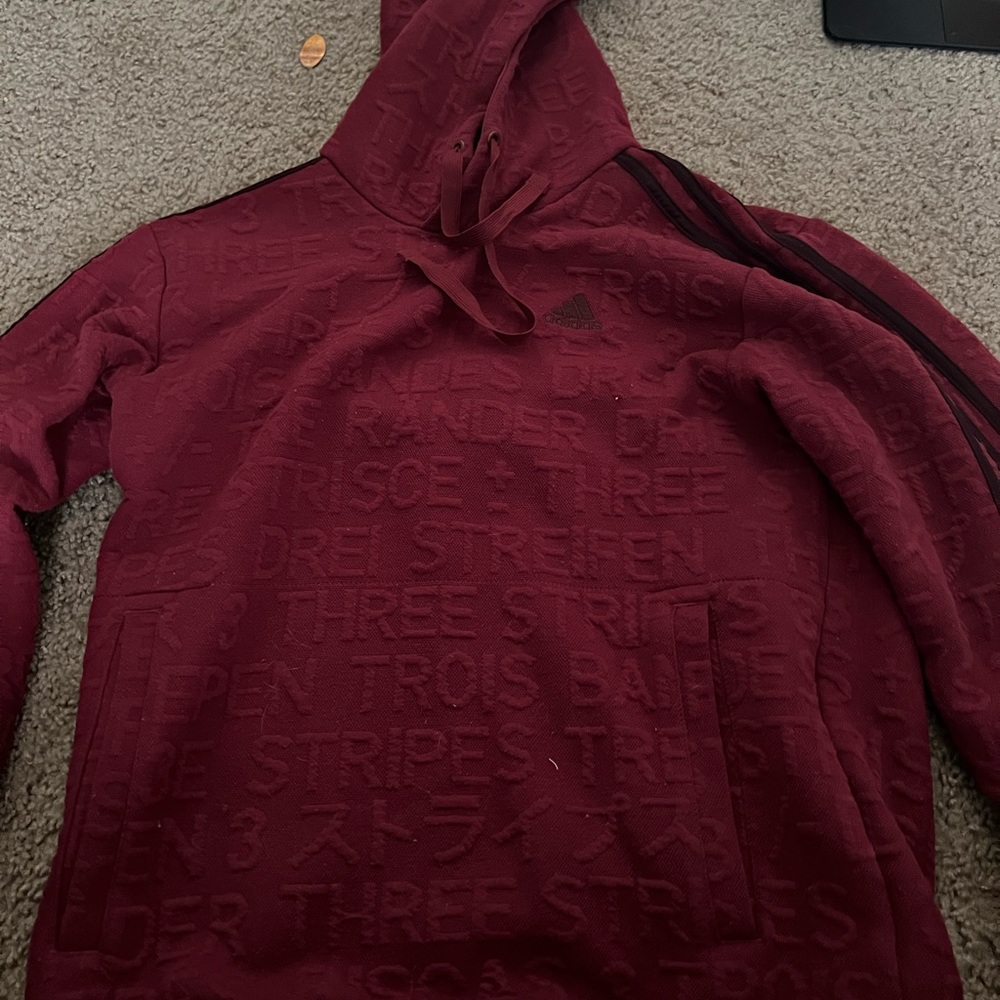 Red adidas sweatshirt.